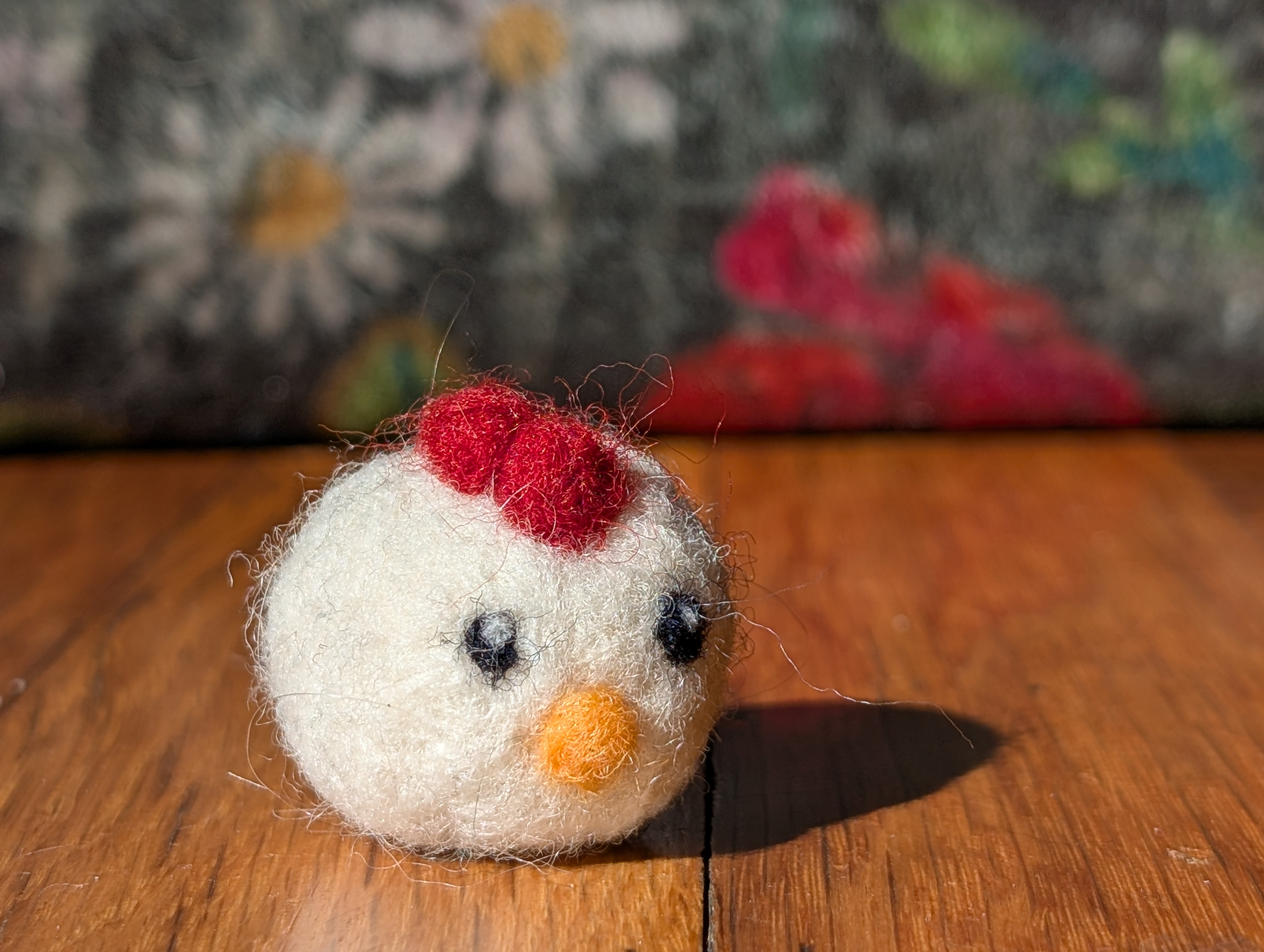 Needle felted chicken with fluffy white feathers and a bright red comb